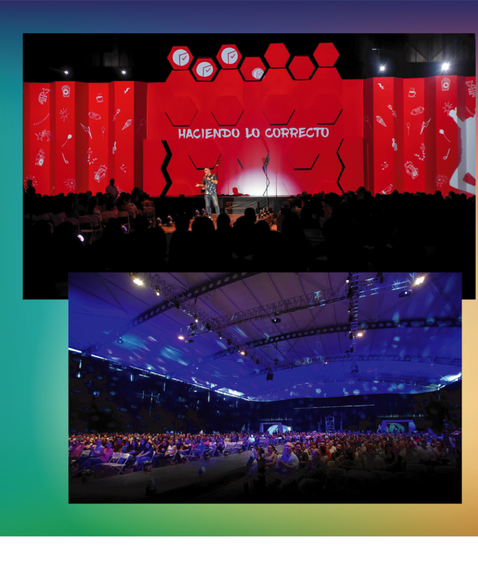 Large corporate stage experience with red visual identity and a full audience